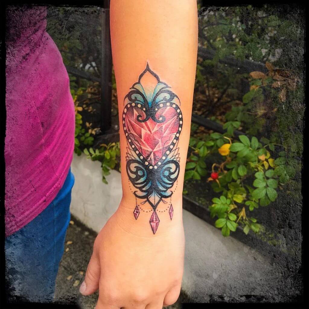 Color Forearm tattoo of a red diamond heart