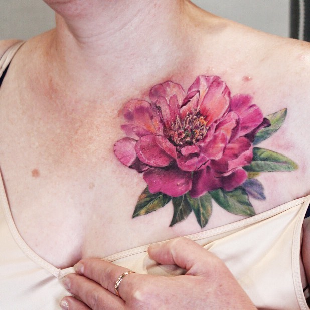 Color Rose tattoo on the left clavicle