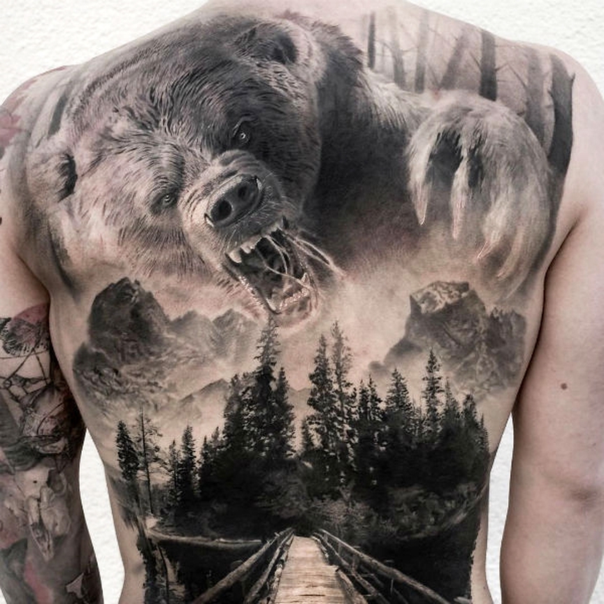 3D Black tattoo of a bear and nature on the back