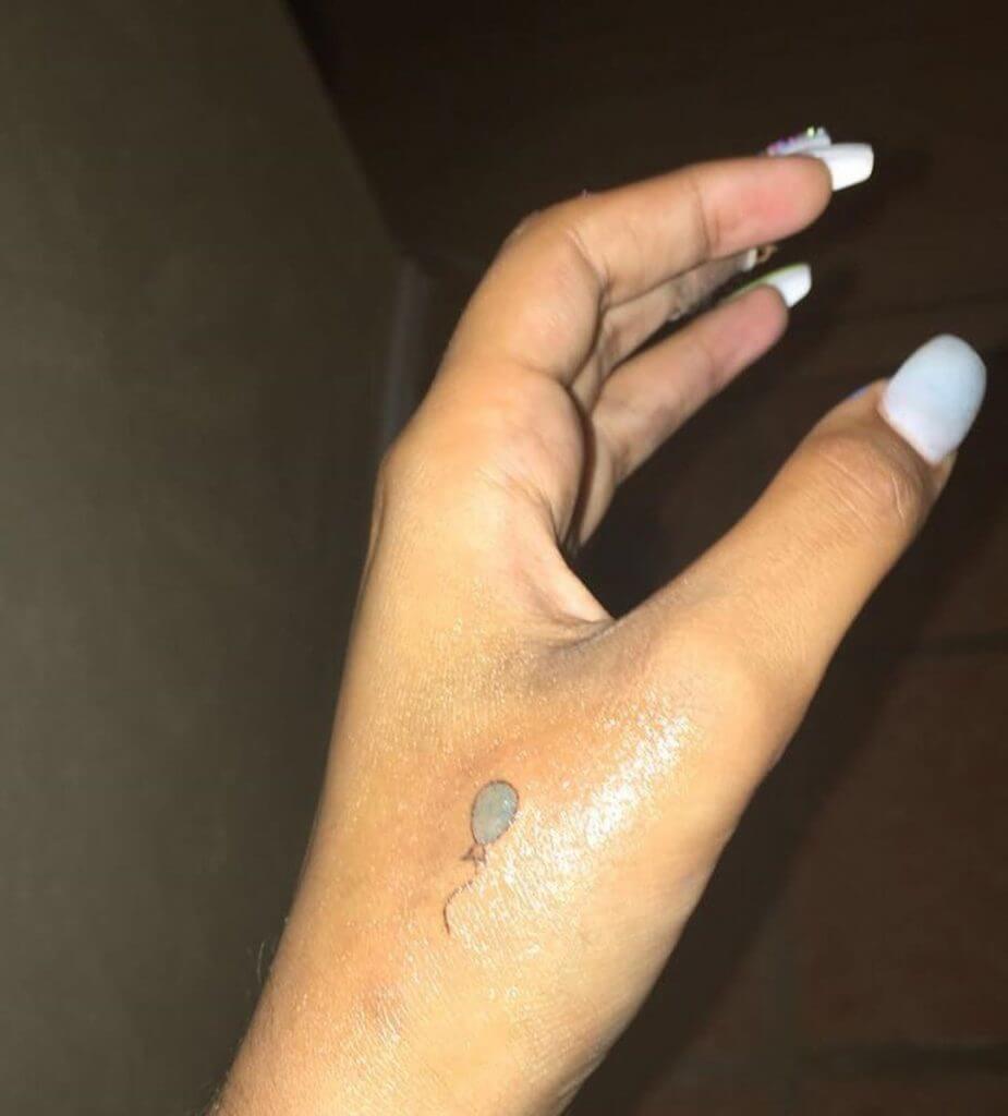 Small Color tattoo of a balloon on the left hand