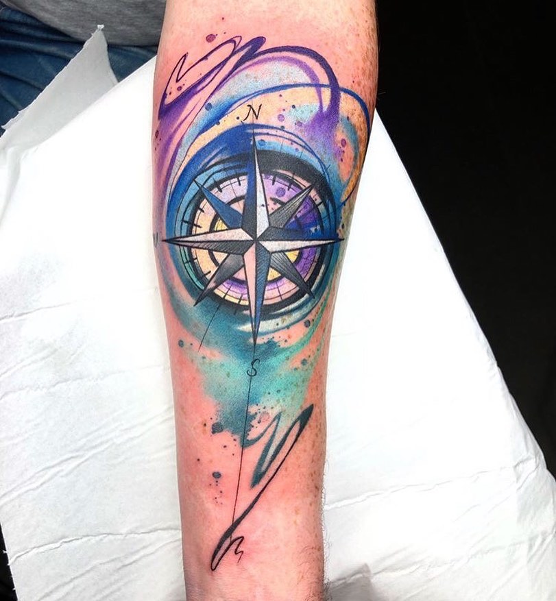 Watercolor Compass tattoo on a forearm
