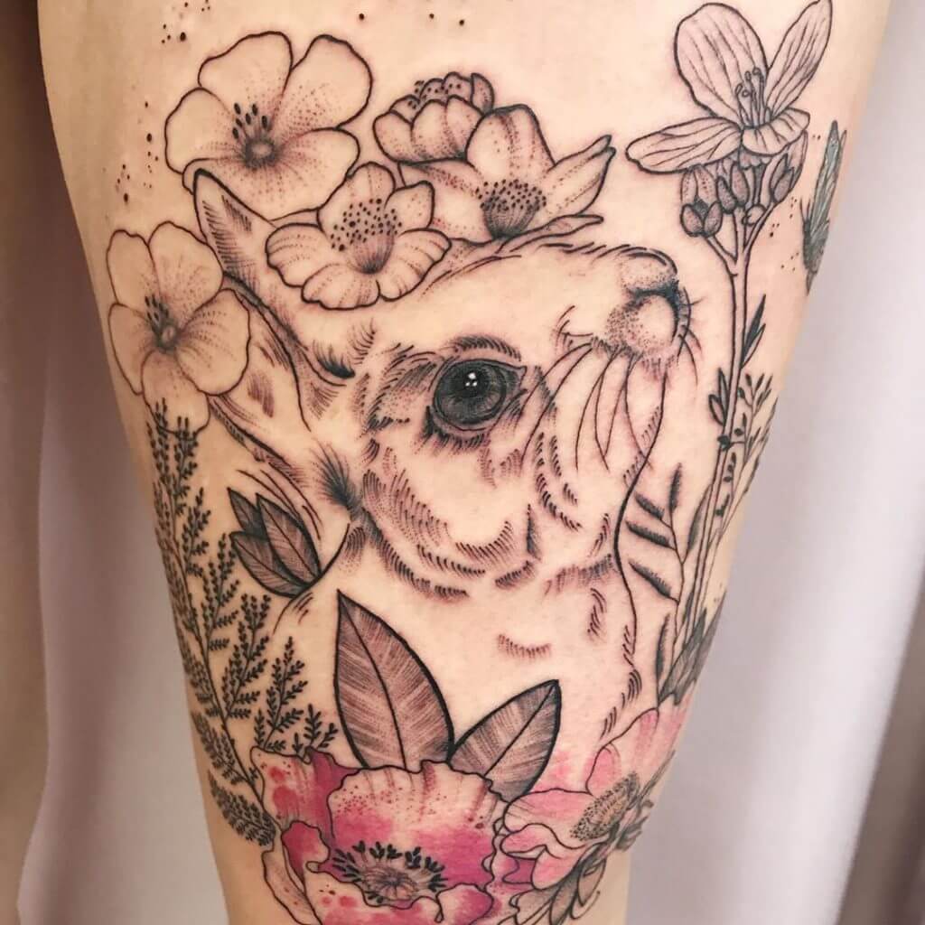 Color Bunny tattoo with flowers on the left thigh