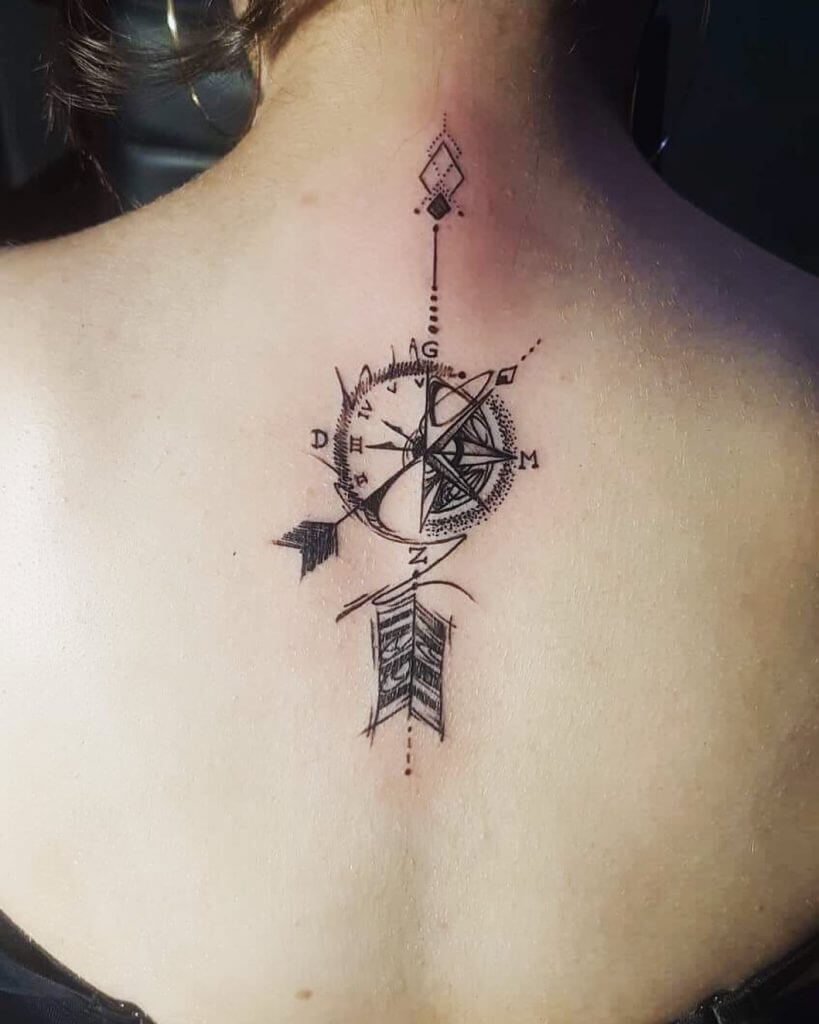 Black Compass tattoo with arrows on the back