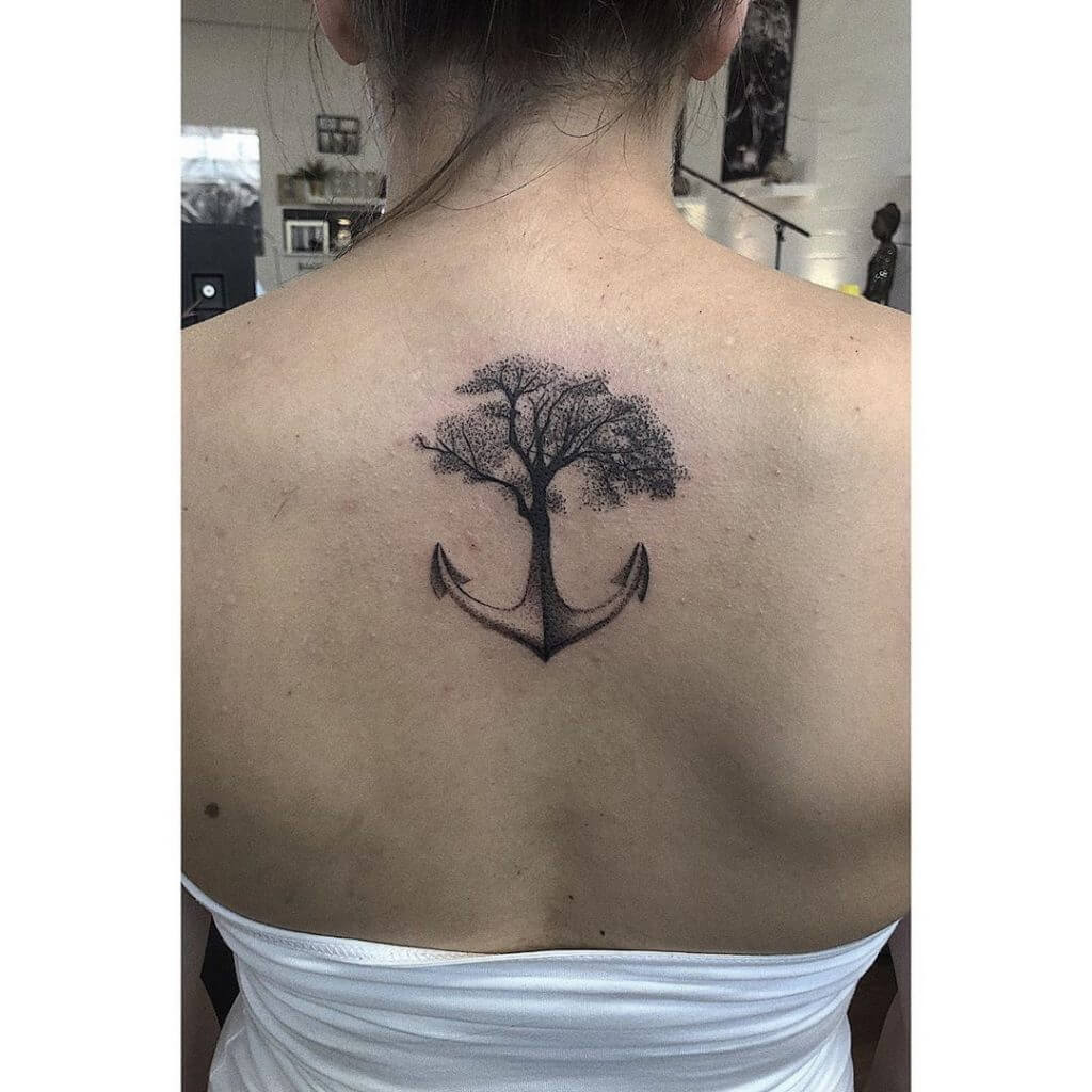 Black Anchor tattoo with a tree on the back