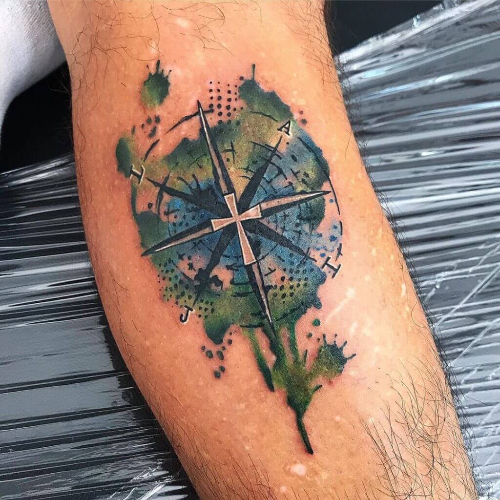Watercolor Compass tattoo on the left calf