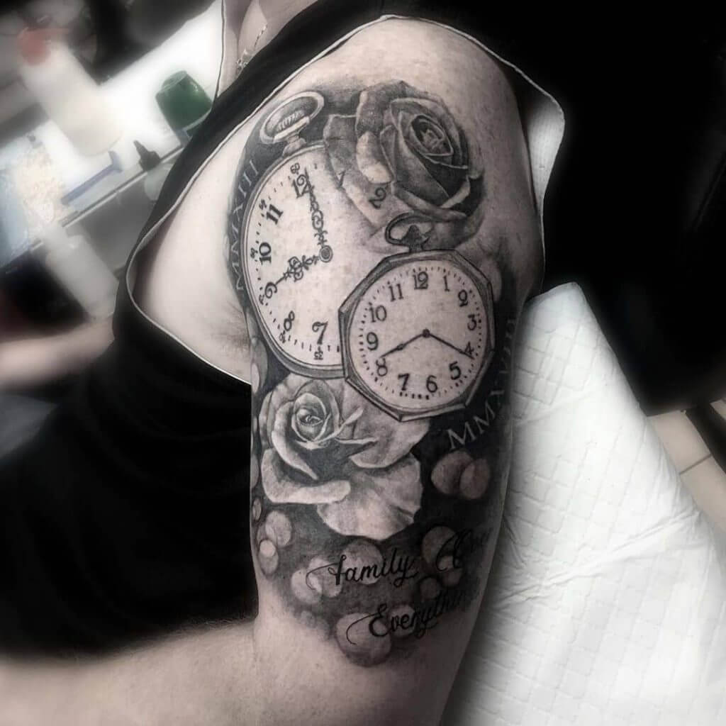 Black Male tattoo of watches with roses on the left shoulder