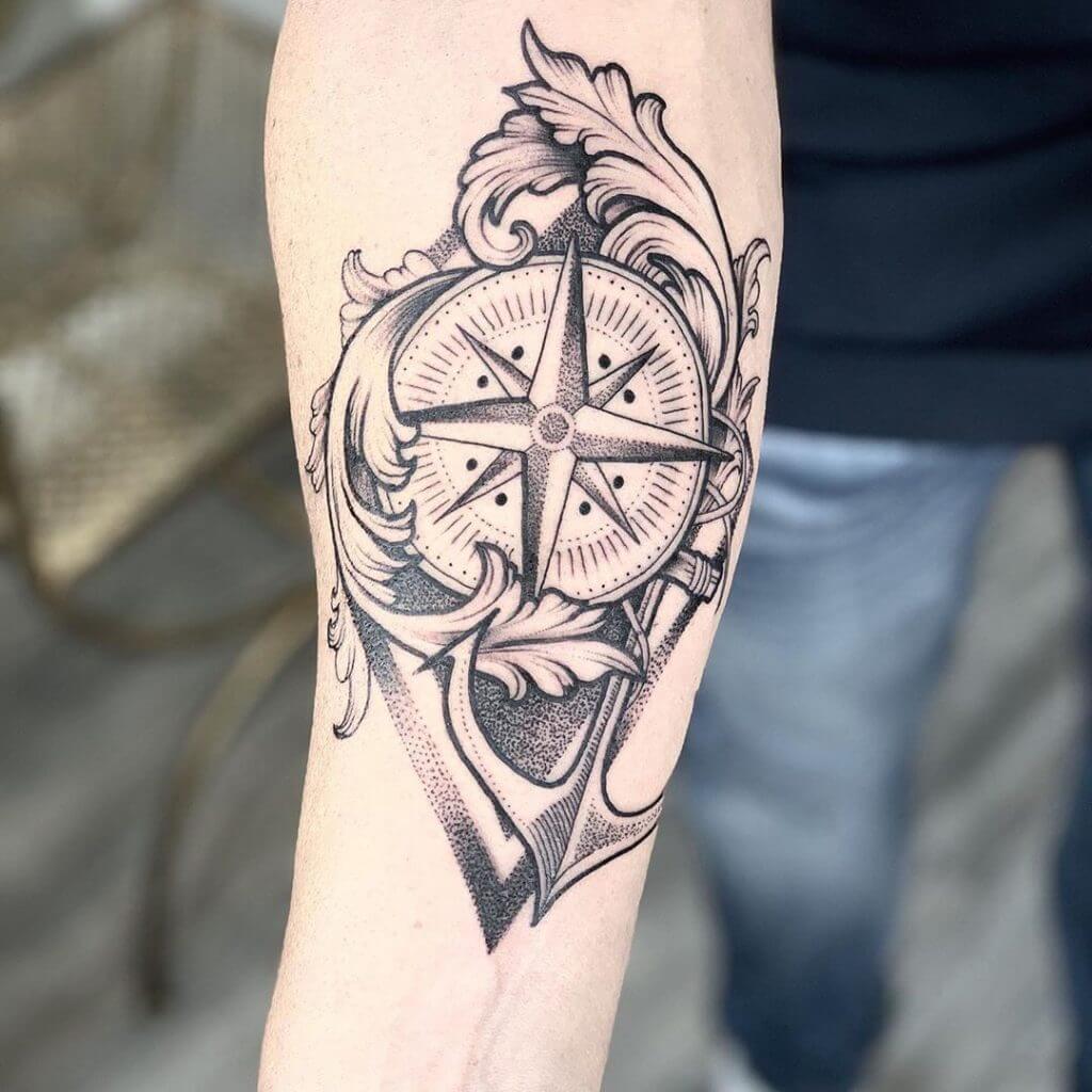 Black Compass tattoo with an anchor on the right forearm