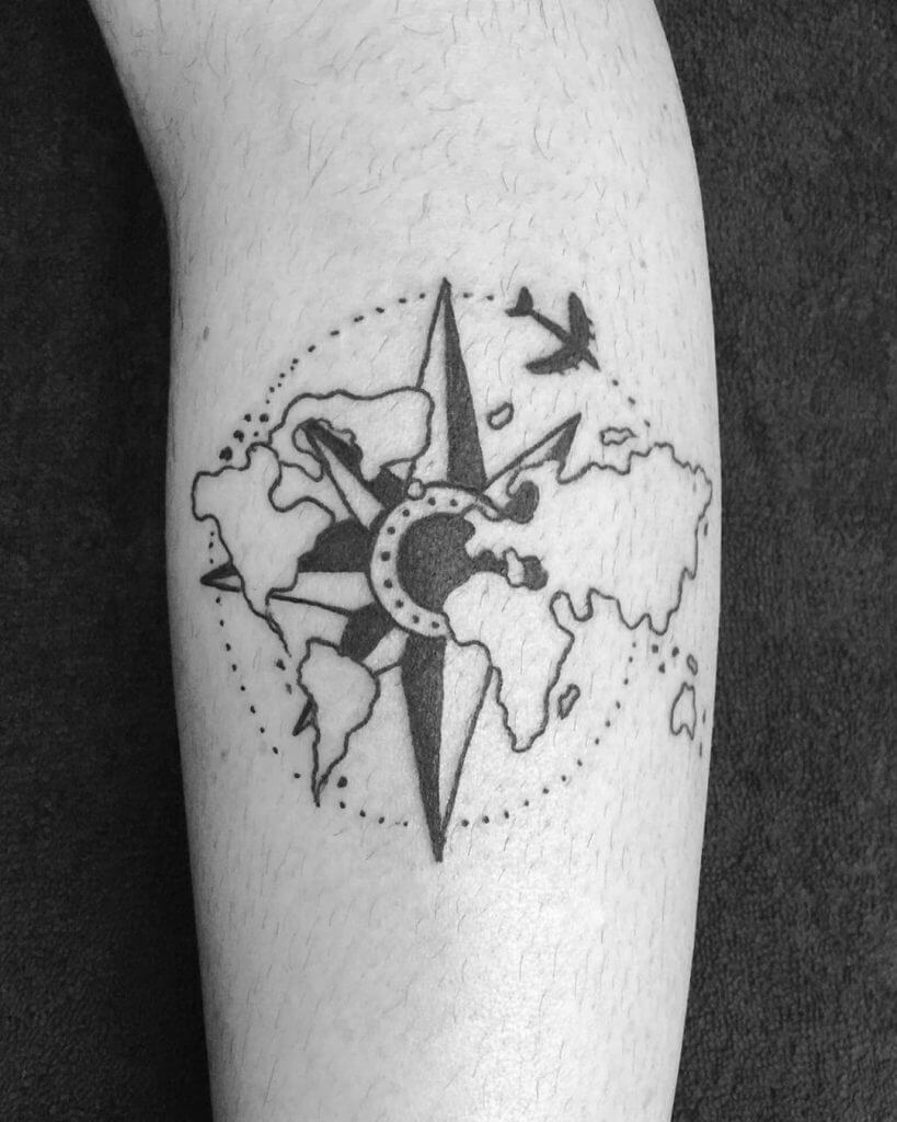 Black Compass tattoo with the world map and an airplane on forearm