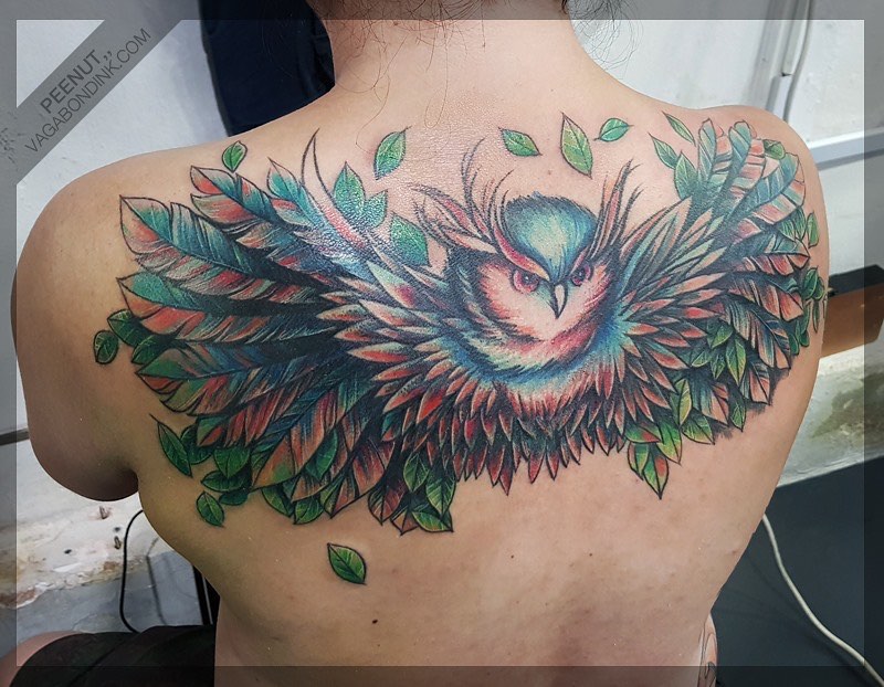 Color Bird tattoo of an owl on the back