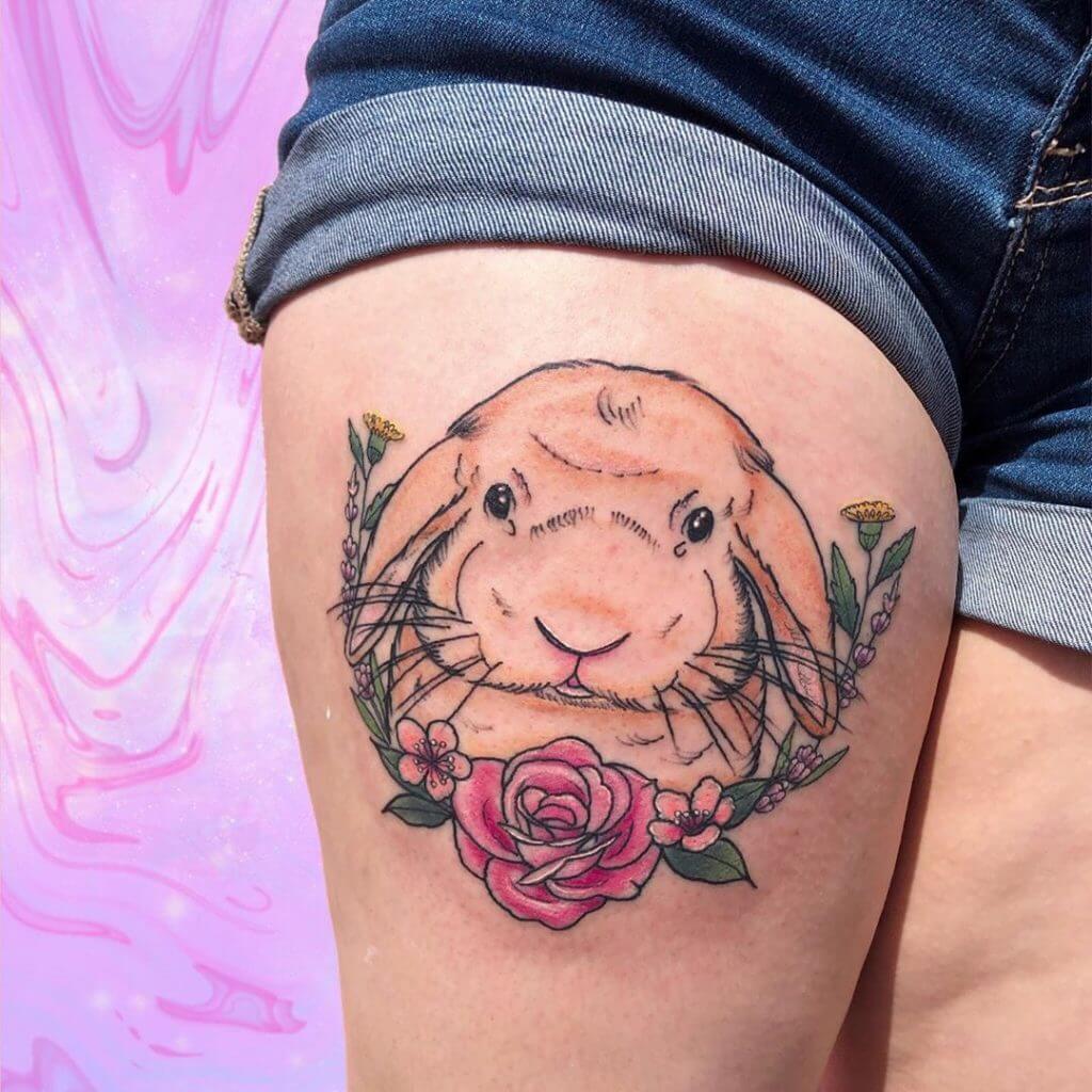 Color Bunny tattoo with flowers on the right thigh