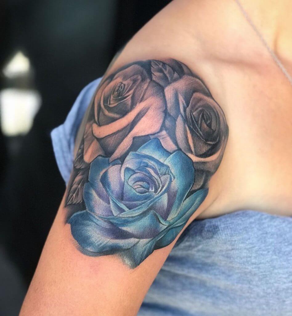 Black and Color Rose tattoo on the right shoulder