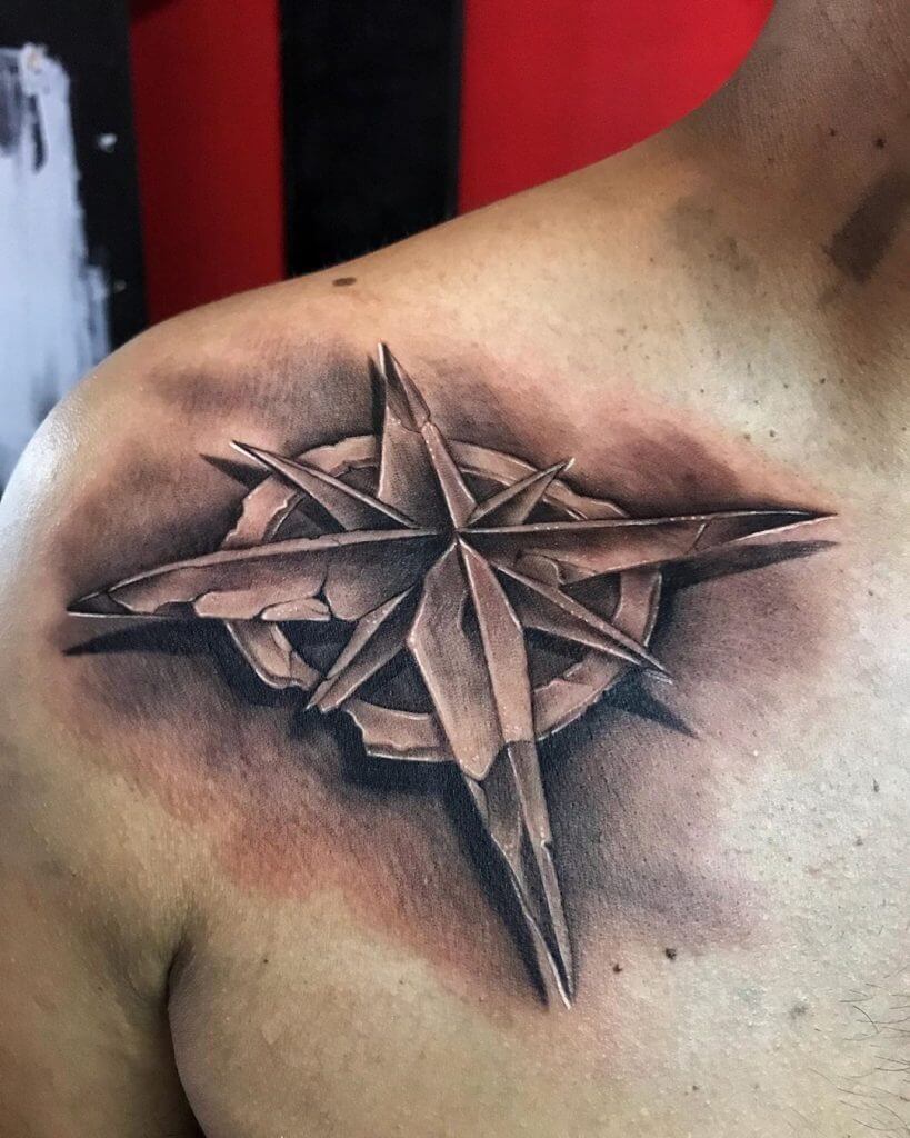 Black and Gray Compass tattoo on the right collar bone