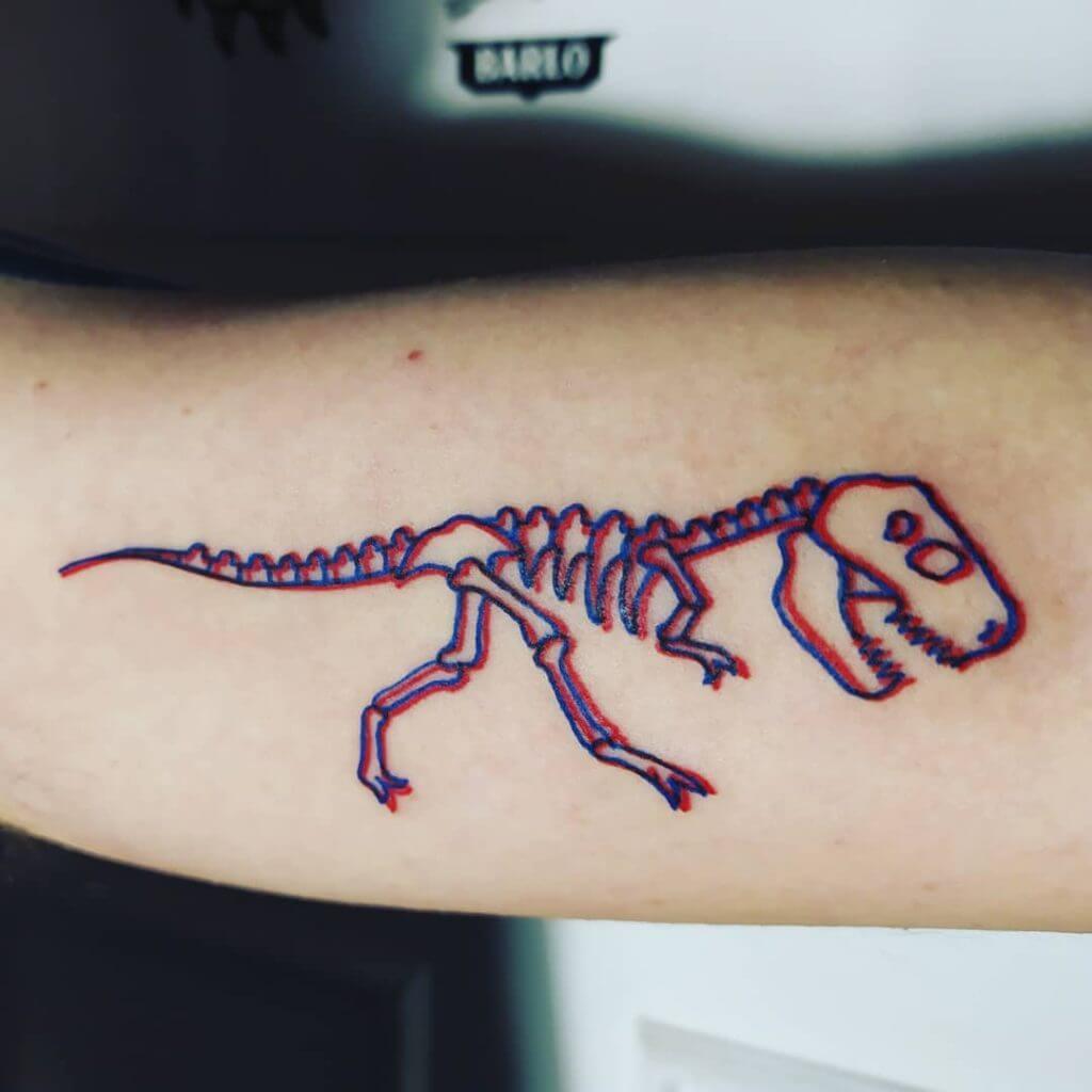 3D tattoo of a dinosaur on the right forearm