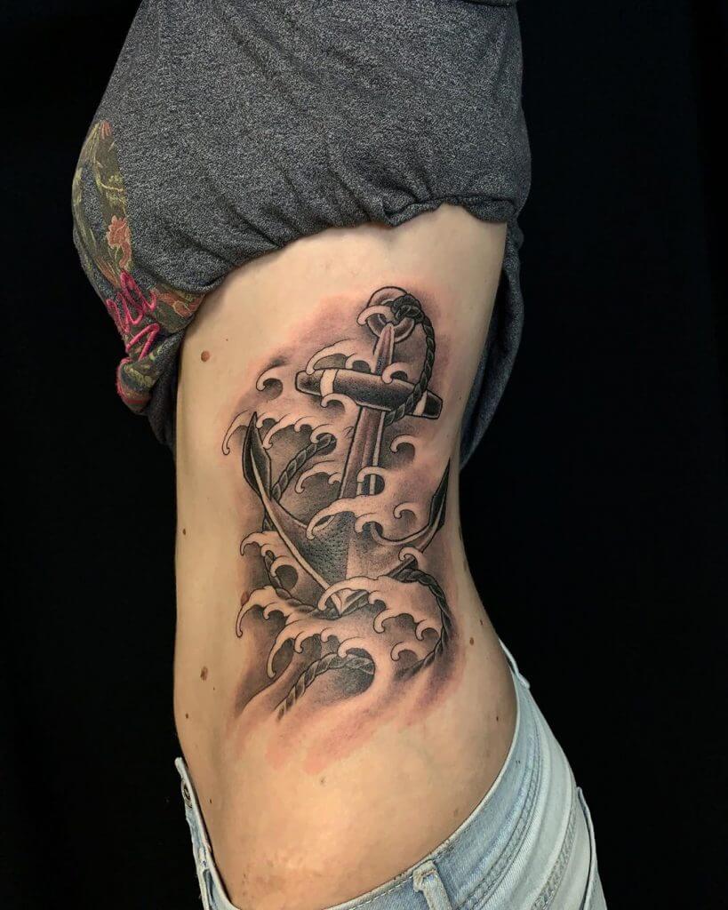 Black and Gray Anchor tattoo with waves on the ribs
