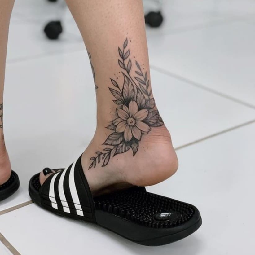 Black Female tattoo of flowers on the right feet
