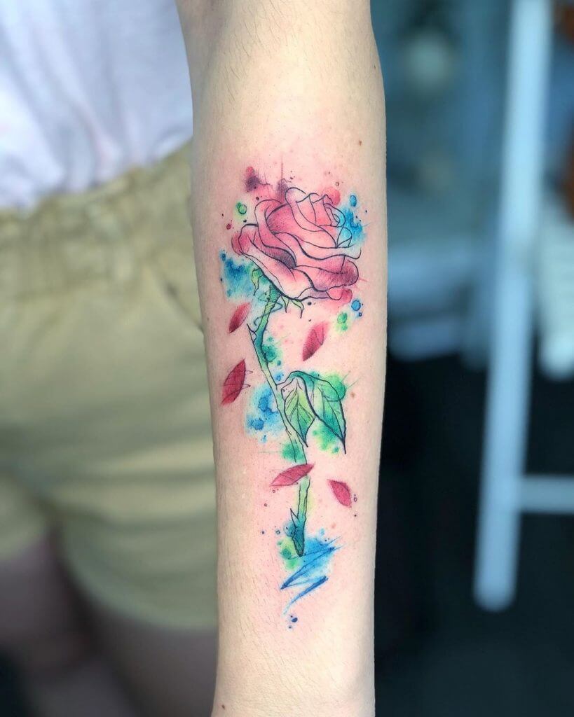 Watercolor Female tattoo of a rose on the left forearm