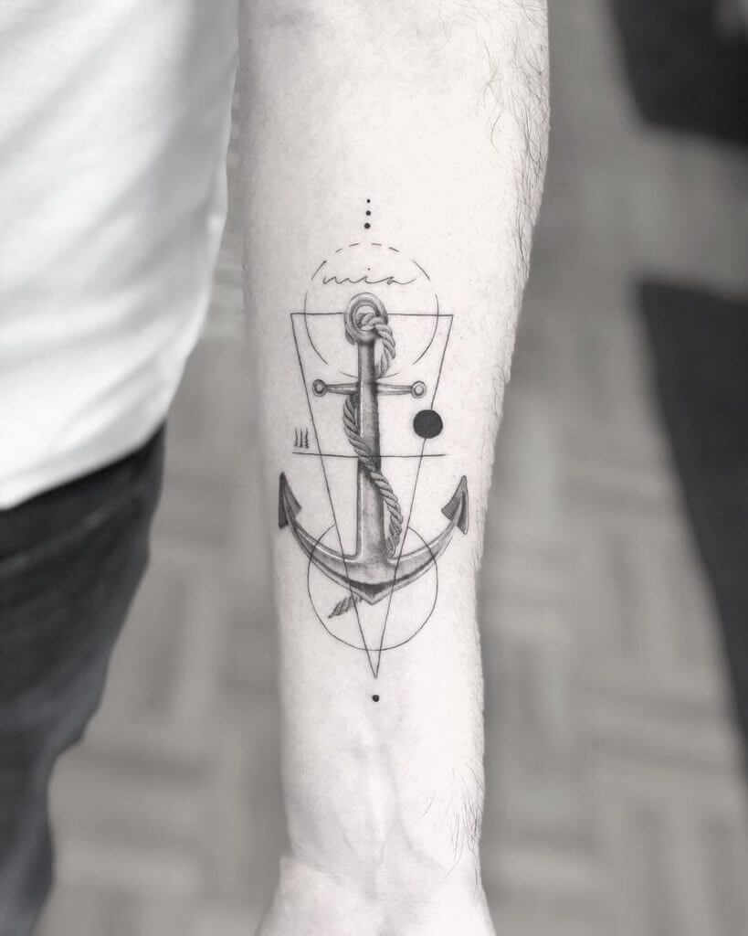 Black Anchor tattoo with a triangle and circles on the left forearm