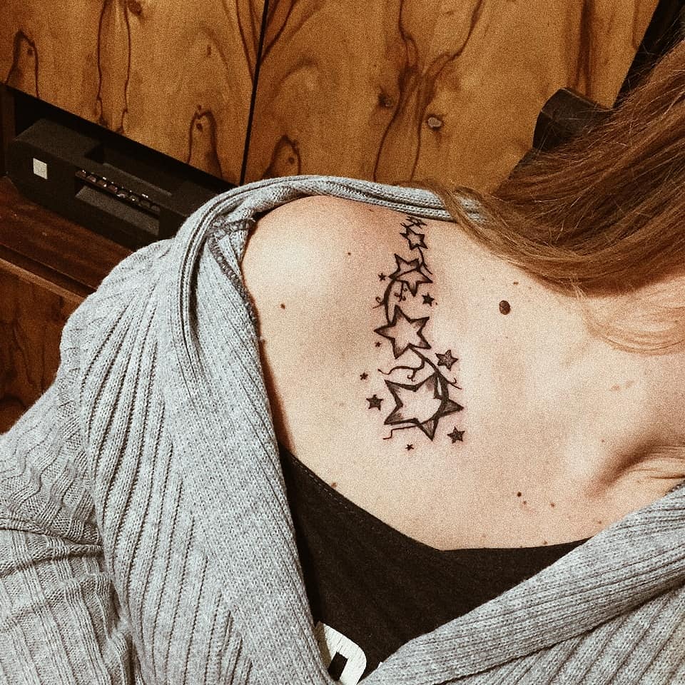 Black Stars tattoo on the right collar bone
