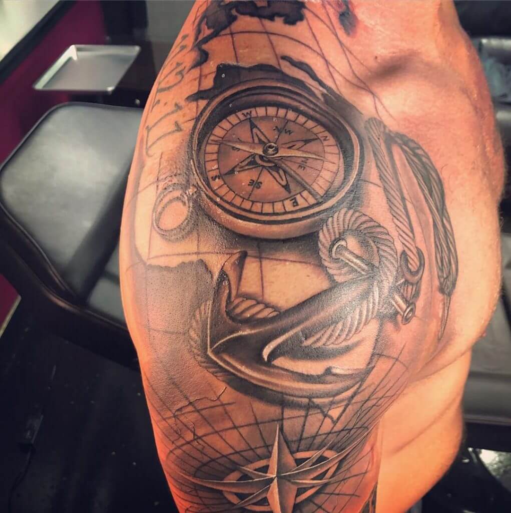 Black Anchor tattoo with a compass on the right shoulder