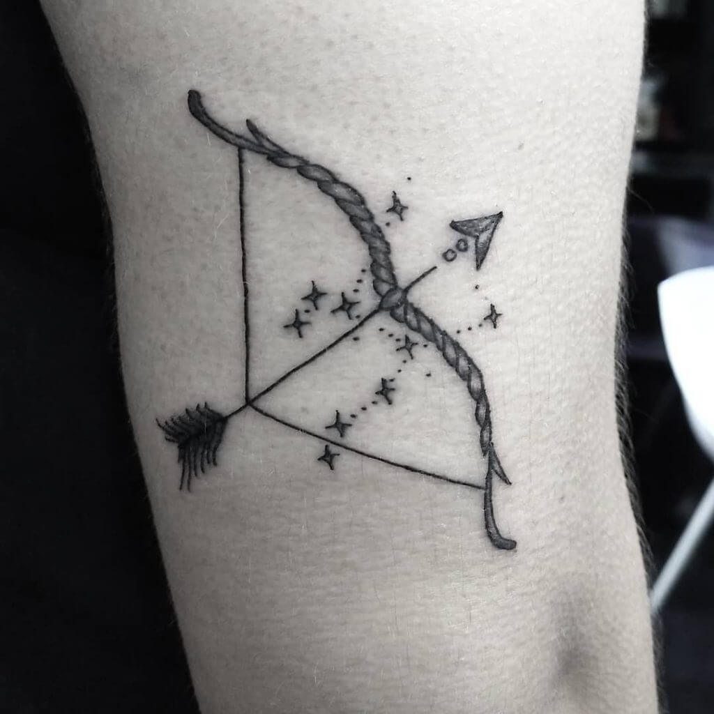 Black Stars tattoo of the horoscope Sagittarius with a bow and an arrow on the arm