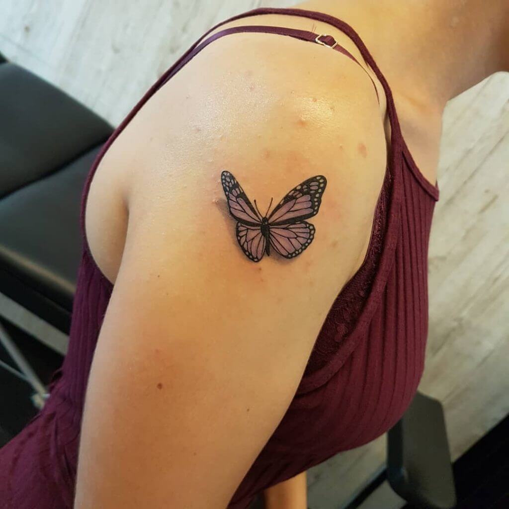 Color Female tattoo of a butterfly on the right shoulder