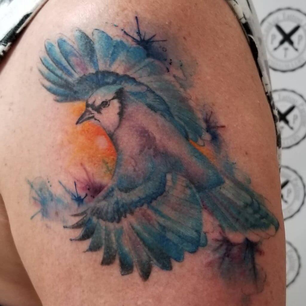 Color Bird tattoo on the left shoulder