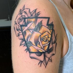 Black and Color Rose tattoo on the right shoulder