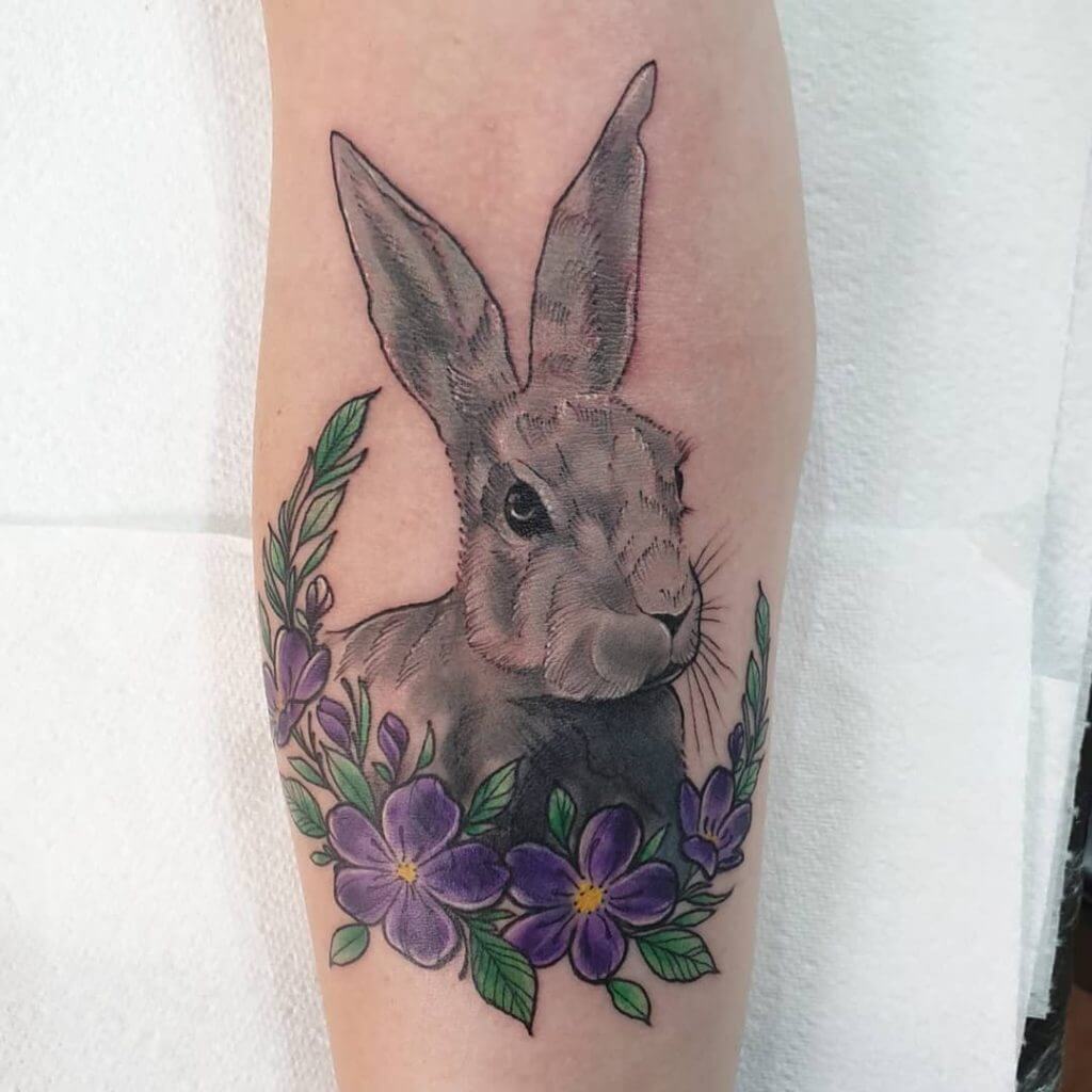 Color Bunny tattoo with flowers on the right forearm