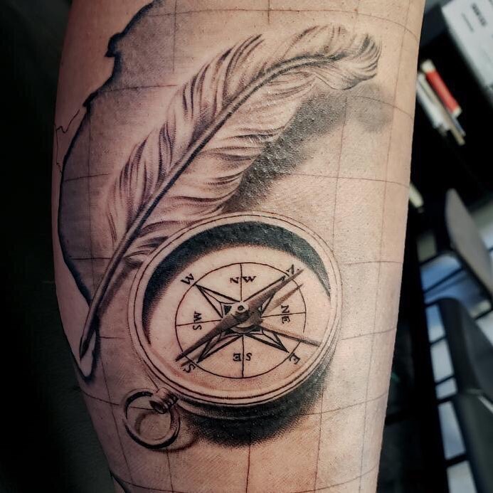 Black and Gray Compass tattoo with a feather