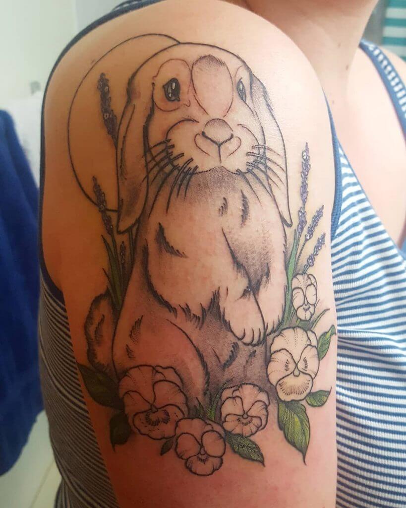 Color Bunny tattoo with flowers on the right shoulder