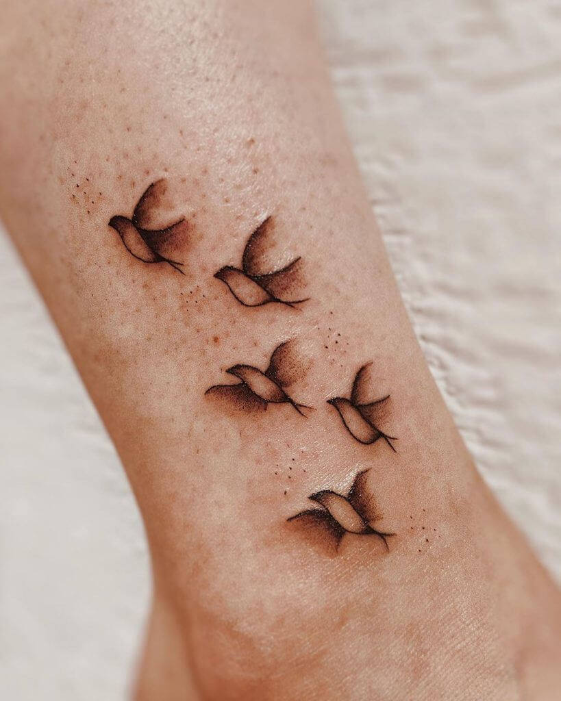 Small Black and Grey tattoo of birds on the right foot