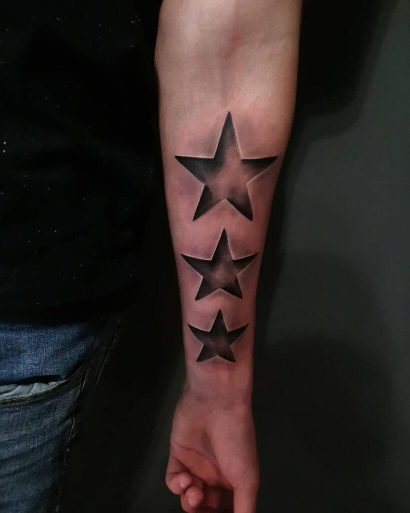 3D tattoo of stars on the left forearm
