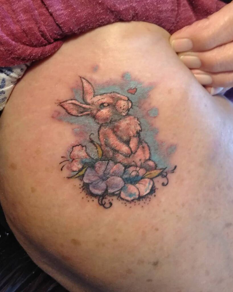 Color Bunny tattoo with flowers on the right arm