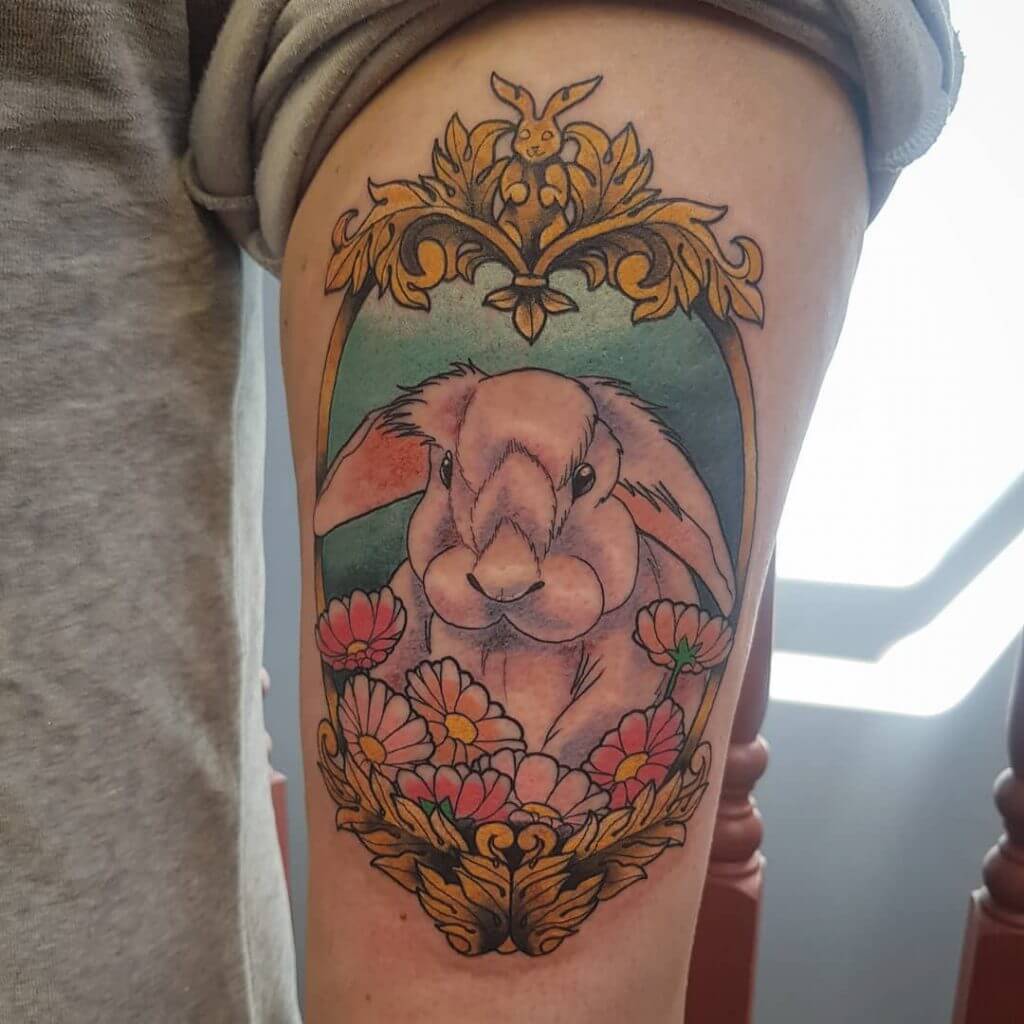 Color Bunny tattoo with flowers on the left arm