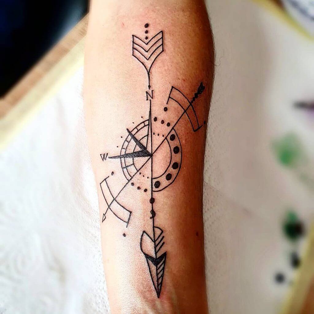 Black Compass tattoo with arrows on the left forearm
