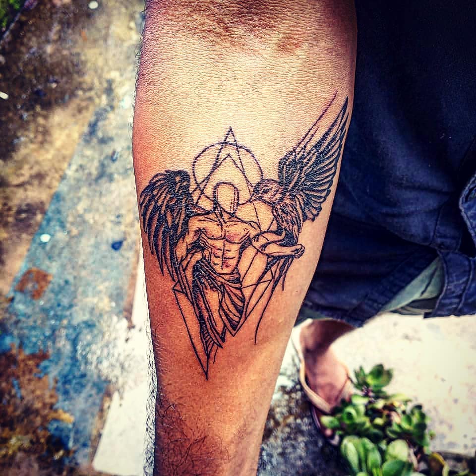 Male tattoo, of an angel with a bird on the right forearm