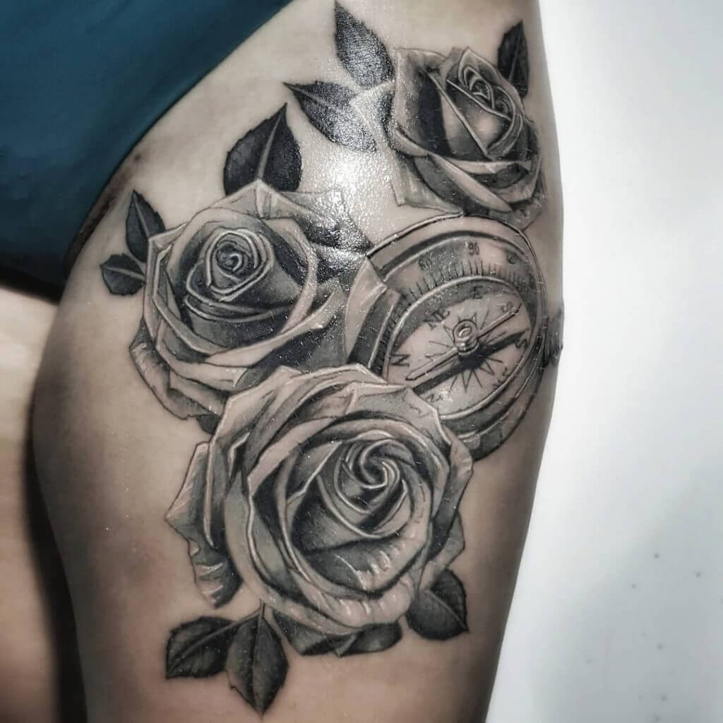 Black and Gray Compass tattoo with roses on the left thigh