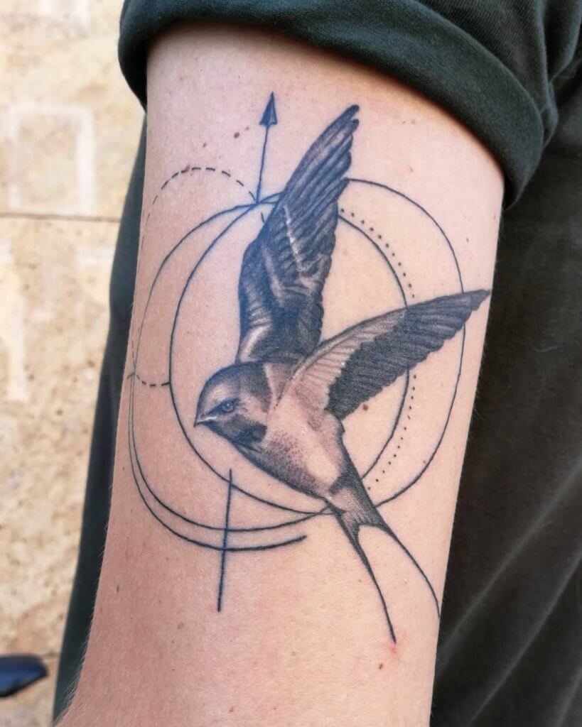Bird tattoo of a swallow on the left arm