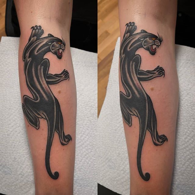 Traditional color tattoo of a black Panther on the leg