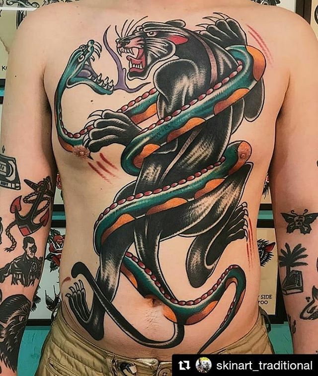 Traditional tattoo of a Panther fighting a snake on the whole chest