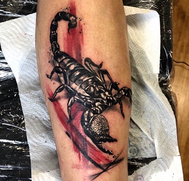Trash polka tattoo of a scorpion on the leg