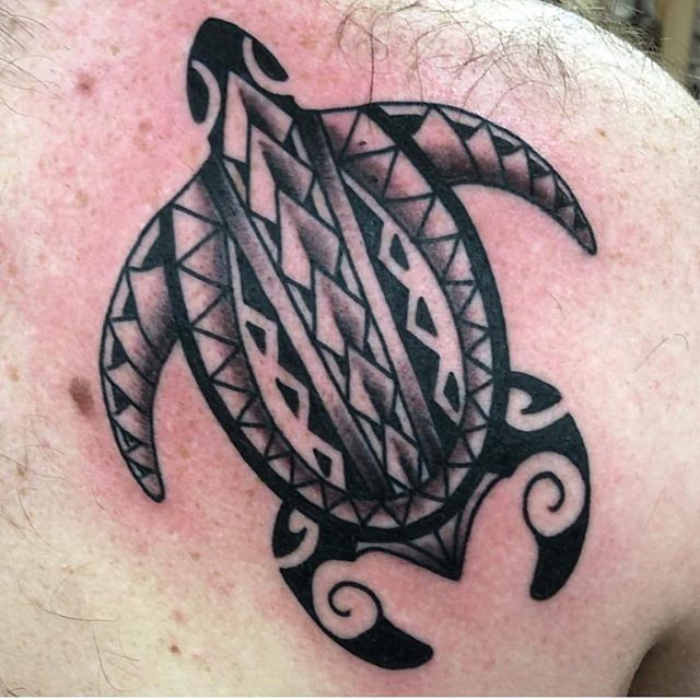 Tribal tattoo of a turtle on the back