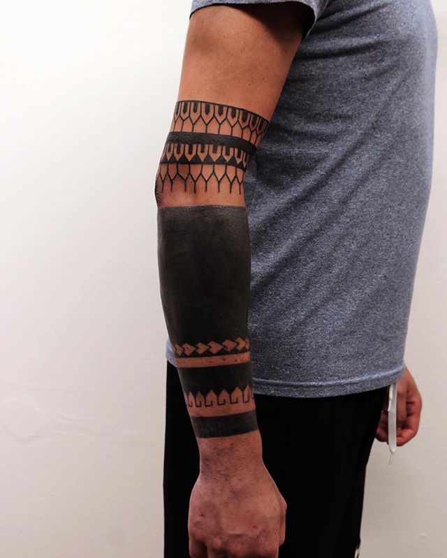 Tribal tattoo on the right forearm