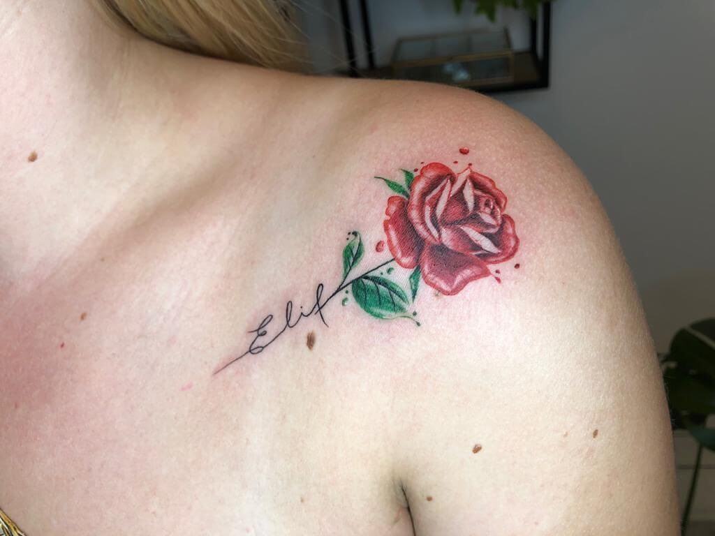 A color rose tattoo of a rose on the shoulder