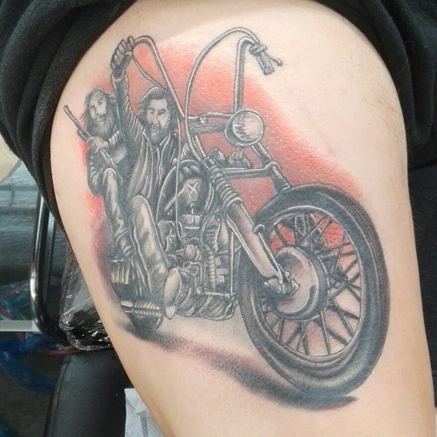 Mens motorbike tattoo of two bikers on the bike