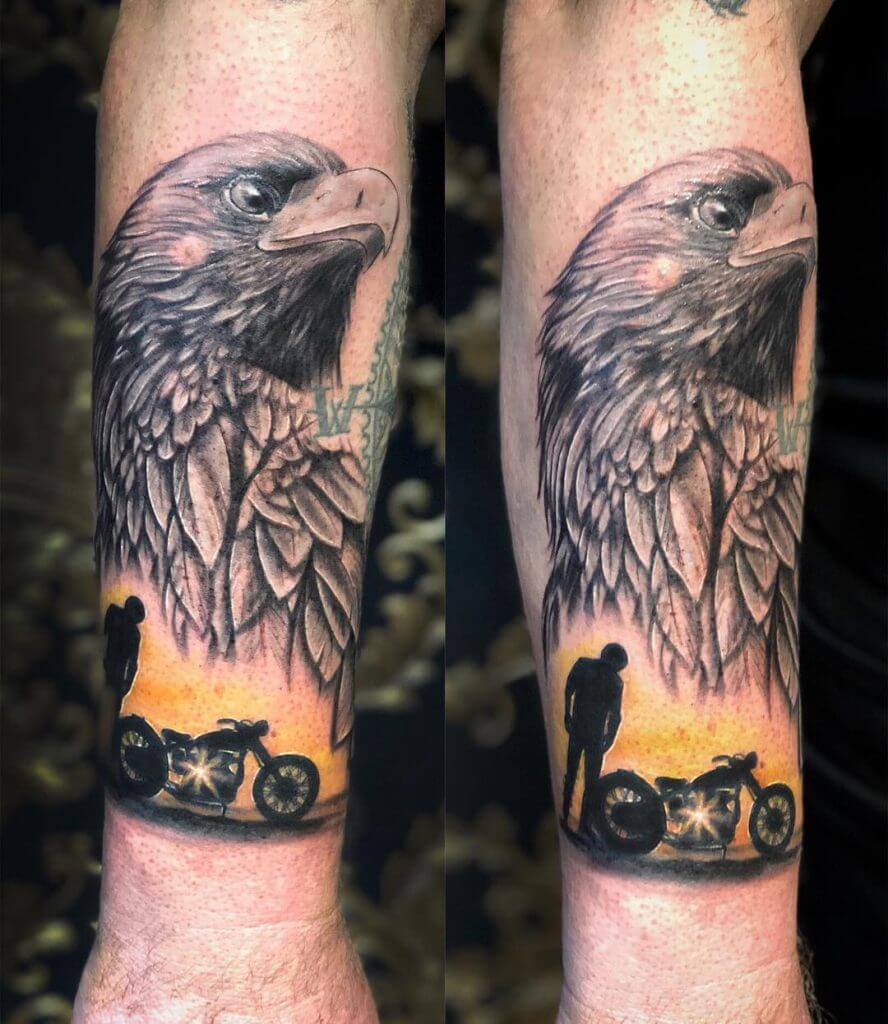 Mens motorbike tattoo of an eagle, a man and a bike on the forearm