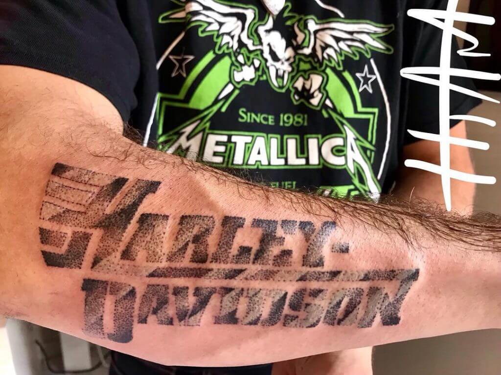 Mens motorbike tattoo with Harley Davidson written on the right forearm
