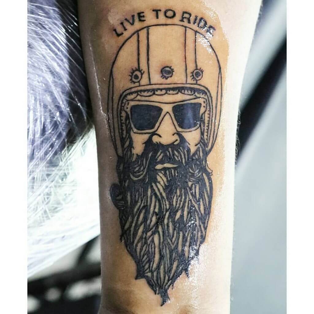 Mens motorbike tattoo of a bearded man on the left forearm