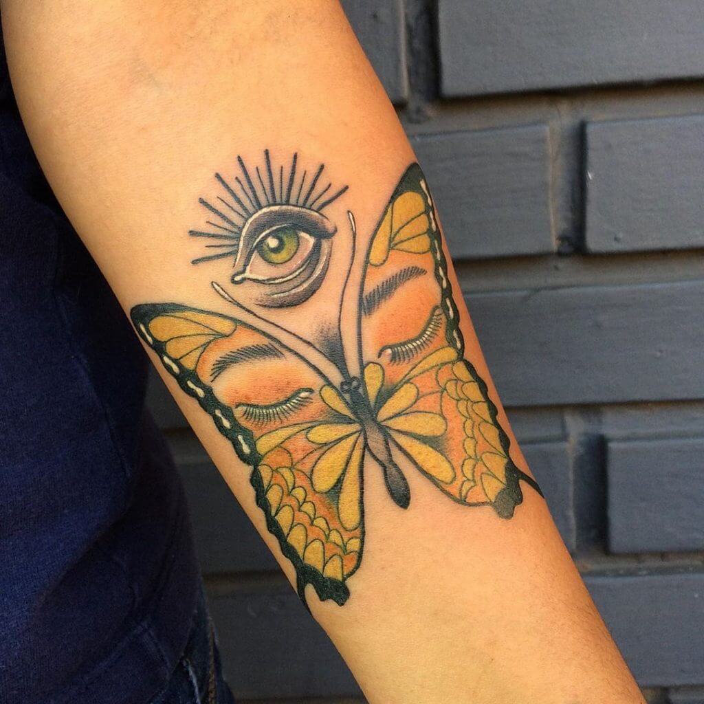 Color Butterfly tattoo with an eye on the left forearm