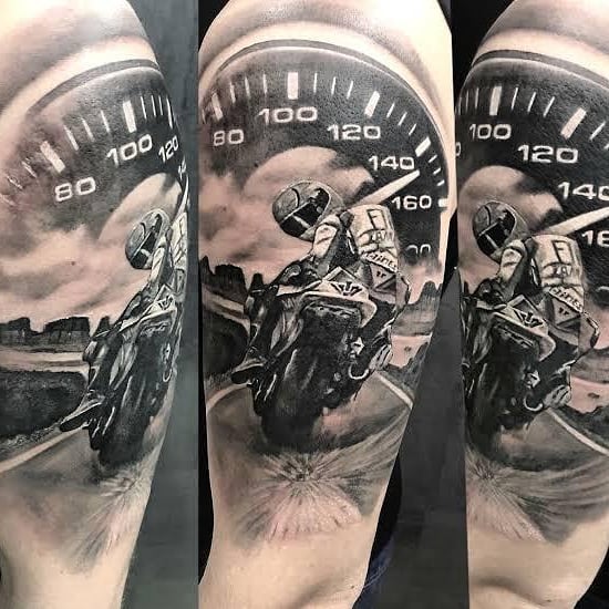 Mens motorbike tattoo of a biker and a speedometer, on the left shoulder